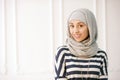 Studio photo of a beautiful young woman dressed oriental type in the Muslim style