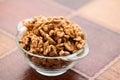 Studio photo of bowl with heap of peeled walnuts