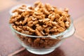 Studio photo of bowl with heap of peeled walnuts