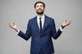 Studio photo of meditative young handsome stylish businessman wearing suit