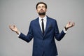 Studio photo of meditative young handsome stylish businessman wearing suit