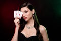 Studio photo stunning woman dealer hold card vip private party poker club poker night neon filters reflect on long hair