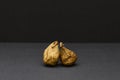 Two dried figs on dark gray background natural healthy snack Royalty Free Stock Photo