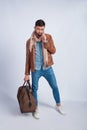 Studio photo of the young man with a travel bag Royalty Free Stock Photo