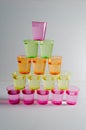 A Studio Photograph of Multicoloured `Shot` Containers in a Pyramid Shape