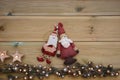 Christmas photography with silver and gold colored acorn tree ornament on natural rustic wood background with santa decorations