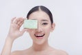 A studio picture of an Asian woman beaming for the camera with a bar of body soap in her hand. Royalty Free Stock Photo