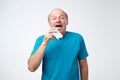 Studio picture of senior man with handkerchief. Sick guy isolated has runny nose. Royalty Free Stock Photo