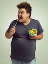 Studio, plus size and man with eating salad for weight loss, healthy diet and vitamin c benefits. Fork, tomato and male Royalty Free Stock Photo