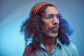 Studio portrait of African Rastafarian male wearing a blue shirt and beanie. Royalty Free Stock Photo