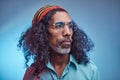 Studio portrait of African Rastafarian male wearing a blue shirt and beanie. Royalty Free Stock Photo