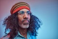 Studio portrait of African Rastafarian male wearing a blue shirt and beanie. Royalty Free Stock Photo