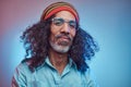 Studio portrait of African Rastafarian male wearing a blue shirt and beanie. Royalty Free Stock Photo