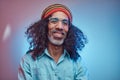 Studio portrait of African Rastafarian male wearing a blue shirt and beanie. Royalty Free Stock Photo