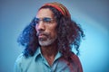 Studio portrait of African Rastafarian male wearing a blue shirt and beanie. Royalty Free Stock Photo