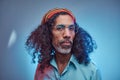 Studio portrait of African Rastafarian male wearing a blue shirt and beanie. Royalty Free Stock Photo