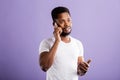 Studio portrait of american man posing with smartphone