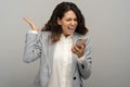 Angry business woman screaming loudly into a mobile phone, shouting calling on smart phone, isolated Royalty Free Stock Photo