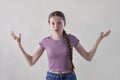 Studio Portrait Of Angry And Frustrated Teenage Girl Looking At Camera