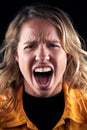 Studio Portrait Of Angry Woman Shouting At Camera Against Black Background Royalty Free Stock Photo