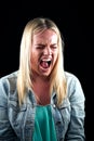 Studio Portrait Of Angry Woman Shouting At Camera Against Black Background Royalty Free Stock Photo