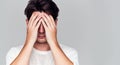 Studio Portrait Of Ashamed Young Man Covering Face With Hands Royalty Free Stock Photo