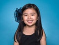 Studio portrait of asian girl with happy look in front of blue background Royalty Free Stock Photo