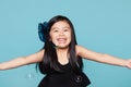 Studio portrait of asian girl with soap bubbles in front of blue background Royalty Free Stock Photo