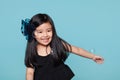 Studio portrait of asian girl with soap bubbles in front of blue background Royalty Free Stock Photo