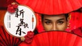 Asian woman eyes behind red chinese fan to celebrate Chinese new year Royalty Free Stock Photo