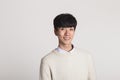 A studio portrait of an Asian young man looking for a camera with confident smiles Royalty Free Stock Photo