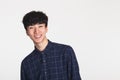 A studio portrait of an Asian young man making a happy smile