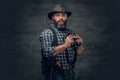 Bearded hunter holds a rifle. Royalty Free Stock Photo