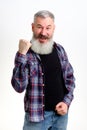 Studio portrait of bearded man in casual clothes raised his hand up, gesture of victory and joy, yes sign, white Royalty Free Stock Photo