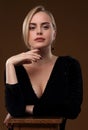 Blonde girl in a black dress with a deep neckline Royalty Free Stock Photo