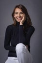 Studio portrait of a beautiful middle-aged woman looking at the camera against isolated dark background Royalty Free Stock Photo