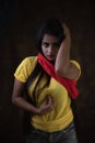 Studio portrait of a beautiful and young Indian Bengali female model in yellow tee shirt and jeans hot pat Royalty Free Stock Photo