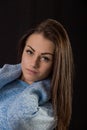 Studio portrait of beautiful young woman with long brown hair wearing blue sweater Royalty Free Stock Photo