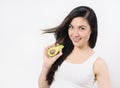 Studio portrait of a beautiful young woman posing with an avocado over white isolated background