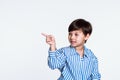 Studio portrait of a boy pointing at something with a finger