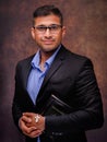 Caucasian christian man with glasses in business suit holding holy bible with jesus cross