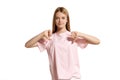 Studio portrait of a beautiful girl blonde teenager in a pink t-shirt posing isolated on white background. Royalty Free Stock Photo