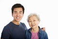 Studio Portrait Of Chinese Mother With Adult Son