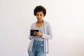 Studio portrait of confident pensive African American young woman writing down in notebook diary remind memories Royalty Free Stock Photo