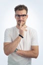 Studio portrait of confident young man asking silence and standing against isolated white background with copy space Royalty Free Stock Photo
