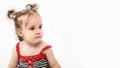 Studio portrait of cute, adorable, sad, upset, crying caucasian toddler girl in dress on isolated white background Royalty Free Stock Photo