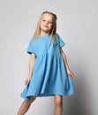 Studio portrait of a cute beautiful little girl in a blue summer dress on a white background. Royalty Free Stock Photo