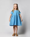 Studio portrait of a cute beautiful little girl in a blue summer dress on a white background. Royalty Free Stock Photo