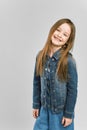Studio portrait of cute little girl in jeans clothes. gray background Royalty Free Stock Photo