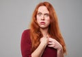 Studio portrait of disaffected woman with red hair Royalty Free Stock Photo